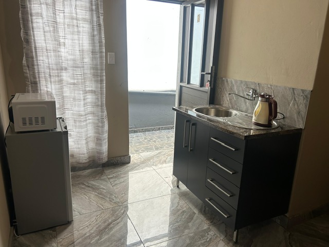 Kitchenette with microwave, fridge and kettle