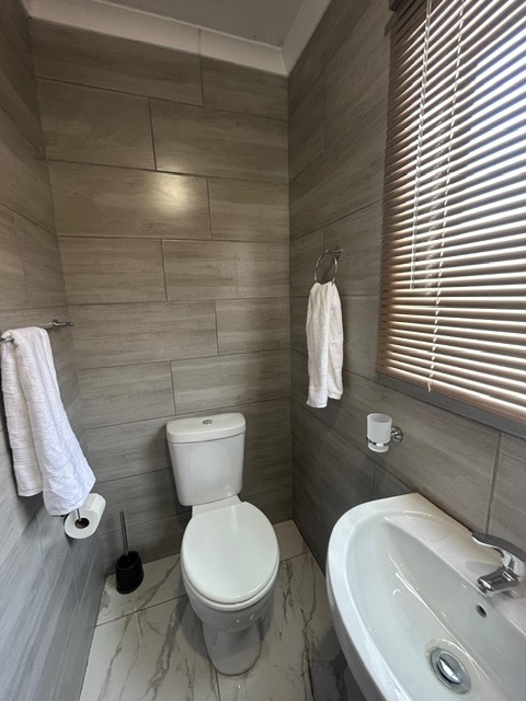 Tiled bathroom with basin